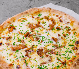Freshly baked gourmet pizza on wooden board