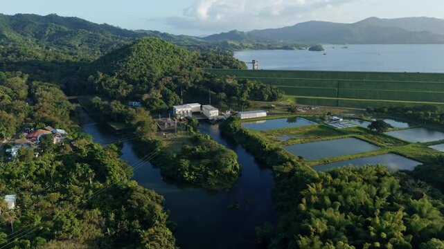 Aerial view of idyllic landscape of Dominican Republic with Hatillo Dam and water reservoir at sunset. Wide shot. Beautiful scenery of Cotui, Sanchez Ramirez.