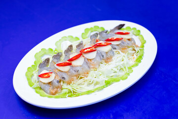 Shrimp soaked in fish sauce spicy in white plate, salty and sour Thai appetizers.