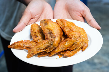 Thai style fried chicken marinated in fish sauce  in white plate.