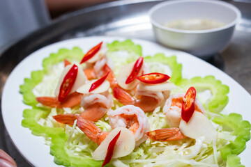 Cooked shrimp soaked in fish sauce spicy in white plate, salty and sour Thai appetizers.