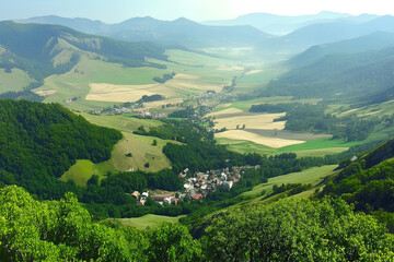 Obraz premium A picturesque view of a small village nestled in the Carpathian Mountains, surrounded by lush green forests and rolling hills, capturing the serene beauty of the mountainous region
