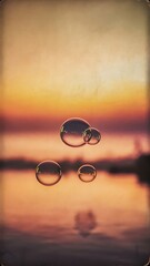 Tranquil background with bubbles floating in the sunset. Image toned in vintage instagram colors. Square composition.