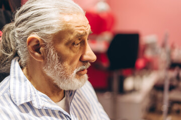 Elderly man contemplating in a cozy setting