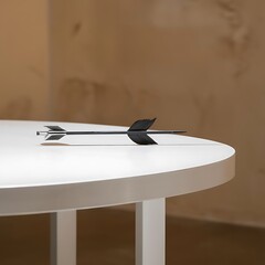 Arrow on white table and beige background