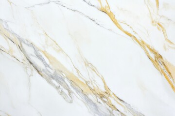 A high-resolution close-up of a white marble surface featuring flowing golden and gray veins
