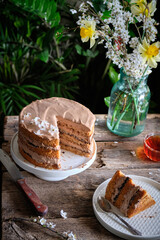 walnut cake with prunes and chocolate decorated with edible flowers. sprin.