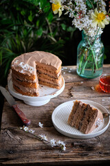 walnut cake with prunes and chocolate decorated with edible flowers. sprin.