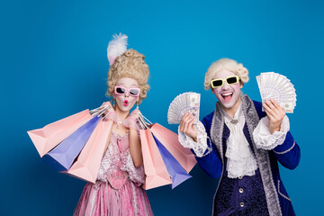 A joyful aristocratic couple in elegant historical costumes expressing excitement against a vibrant blue background.