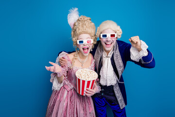 An aristocratic couple in vintage costumes enjoying a modern movie experience, wearing 3D glasses and holding popcorn
