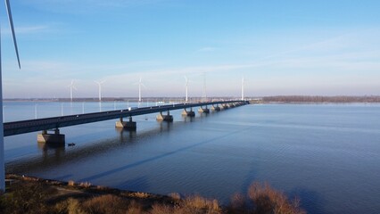 Obraz premium Bridge over the Haringvliet in the Netherlands, a connection between South Holland and Brabant of a steel and metal construction. Maintenance of road network and highway to keep transport active.