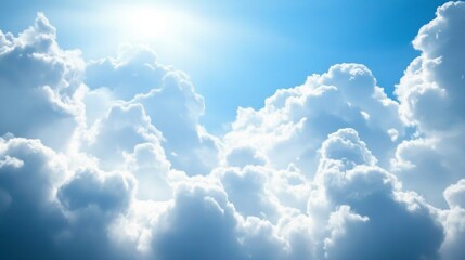 A captivating view of fluffy white clouds gracefully drifting across a vibrant blue sky, illuminated by the warm rays of the midday sun, creating a serene atmosphere