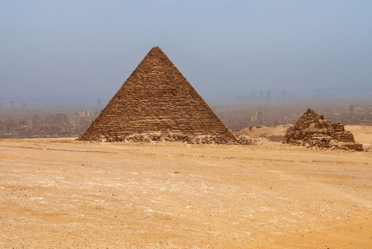 Pyramids of Mikerin (Menkaura) against background of blue spring sky. Close-up. Giza Pyramid Complex is complex of ancient monuments on Giza Plateau in suburbs of Cairo. Cairo, Egypt - April 18, 2008
