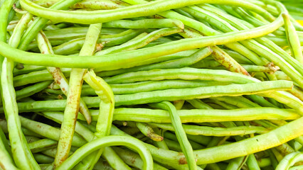 Close-Up of Fresh Green yardlong Beans in a Market Setting