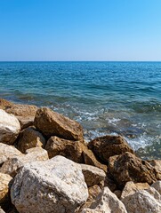 Waves crashing on rocky shore coastal area nature photography sunny day eye-level view tranquil seascape