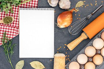 Cooking ingredients with blank notebook. Open recipe book with herbs and spices.