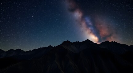 Naklejka premium Stunning night sky showcasing the Milky Way galaxy above majestic mountains, offering a breathtaking view of stars and cosmic beauty in a tranquil wilderness setting. 