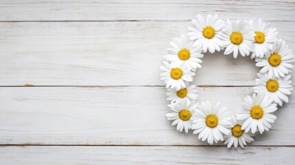 Obraz premium Daisy flower wreath on rustic wooden background for spring decor