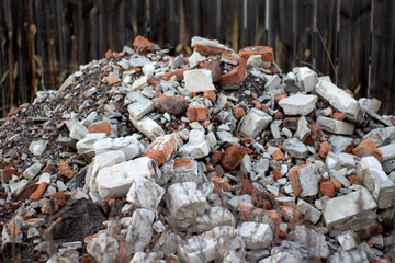 Construction waste with elements of and destroyed old structures at municipal landfill