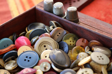 many old buttons are in a box