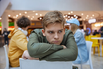 Portrait of upset teenage boy suffering from bullying of friends