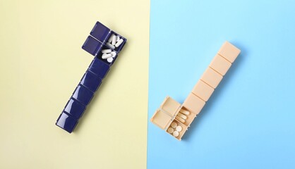 Daily medication organizers arranged on contrasting pastel backgrounds for easy management of pills