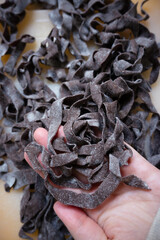 Chocolate pasta making. Freshly made Italian chocolate pasta on a floured surface. Concept of homemade pasta preparation gourmet cuisine, and unique pasta recipes