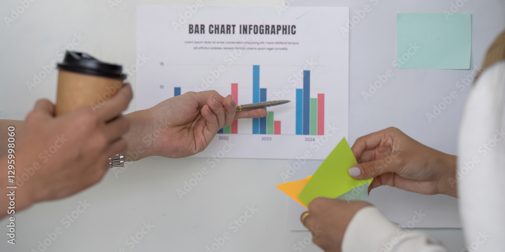 Poster hands discussing financial data with a bar chart infographic, showcasing collaboration in analysis.