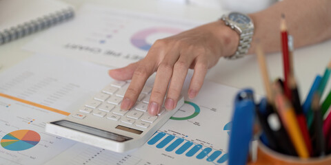 Close-up of a hand using a calculator for financial analysis and budgeting.