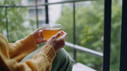 Rare illness patient drinking herbal tea on a balcony with a scenic view. Featuring peace and recovery