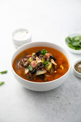 Meat soup with gherkins and olives