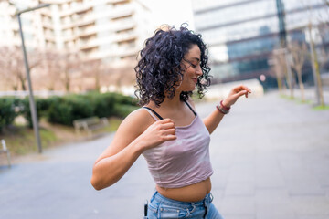 Young latin dancer performing in the city street