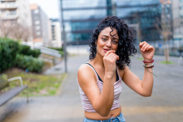 Fototapeta premium Young woman dancing outdoors in urban setting