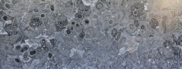 ice pattern on winter glass, abstract background on a cold sunny day