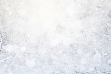white winter background, frosty patterns on glass, abstract backdrop of ice and snow crystals in a blur
