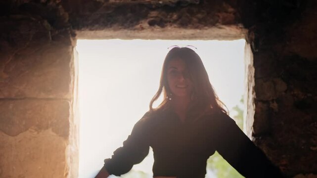 
Smiling and dancing, she embraces the beauty of a historic and touristic location, where nature and ruins coexist in harmony.