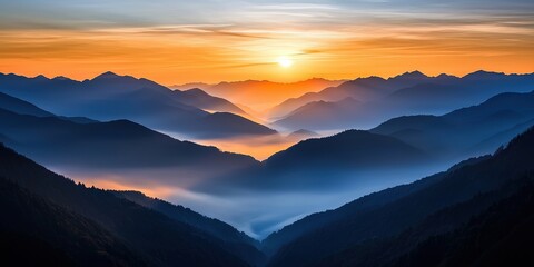 Obraz premium Ethereal mist-covered valley at sunrise, layers of mountains fading into the distance, dreamy and atmospheric natural landscape