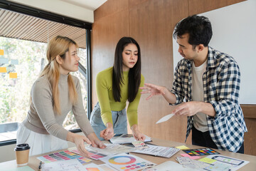 Fototapeta premium Diverse team collaborating on design concepts and discussing feedback in office.