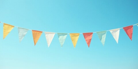 Fototapeta premium Pastel Triangle Bunting Against a Vivid Azure Sky A Festive Celebration Decoration