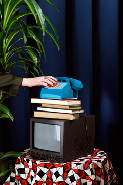 Vintage elegant office studio setup with a retro telephone and books on a television