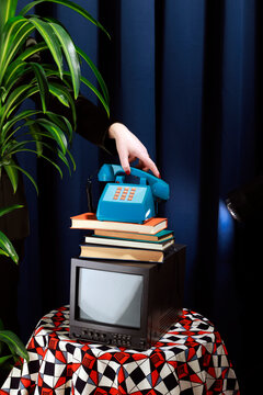 Vintage elegant office studio setup with a telephone, books, and a television