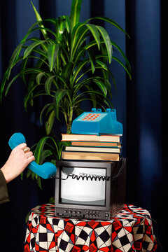Retro still life with telephone, TV, and books in an elegant office setting