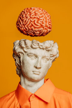 Surreal collage of a classical bust with a floating brain on a yellow background