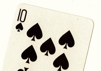Close up of a playing card in sepia.