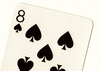 Close up of a playing card in sepia.