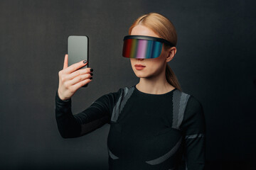 Person wearing VR glasses holding a smartphone in a futuristic setting