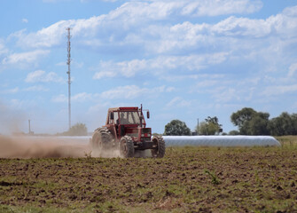 Fototapeta premium a tractor plowing the land