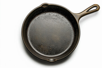 Top-down view of a well-seasoned cast iron skillet against a pristine white background, emphasizing its circular form, cooking surface, and the textured handle.