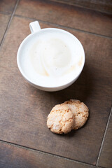 Cappuccino on dark wooden background. Soft focus. Close up.	