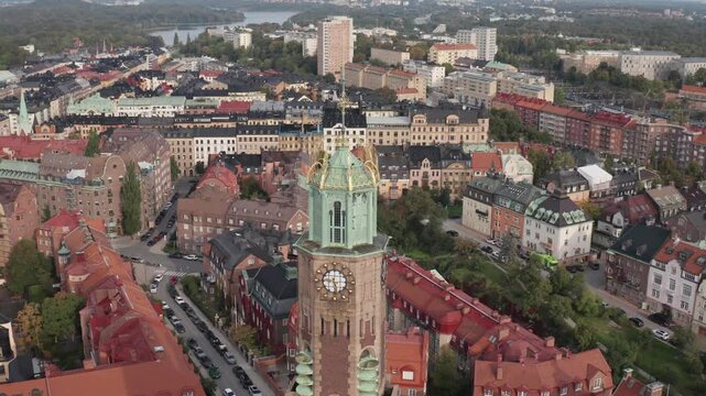 Engelbrektskyrkan in &Ouml;stermalm, Stockholm, Sweden during cloudy sunset in the summer. Aerial shot orbiting left of the top of the church. Skyline, buildings and rooftops in the background.